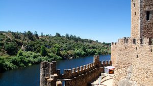 A river on the left and the edge of a castle on the right.