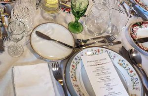 A menu on top of a colorful place setting.