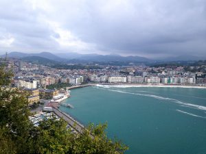 View of a harbor with the city of San Sebastian surrounding it.