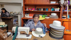 Ecuadorian women sewing traditional hats.