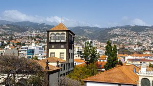 The Sacred Art Museum of Funchal stands against the backdrop of the city.