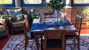 Portuguese table and lounge chair with tiled wall in the background