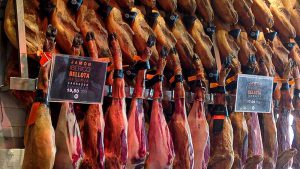 Closeup of hanging ham hocks for sale.