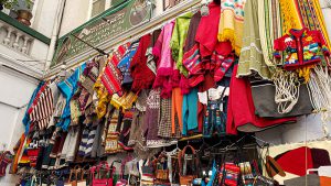 Traditional Ecuadorian crafts hanging in a market.