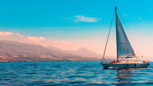Sailboat on the water with mountains in the background