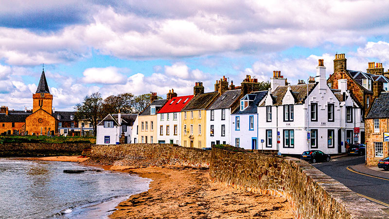 Row of quaint cottages in front of a seawall