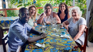 The group of five travelers at a colorful restaurant table at Mionga.